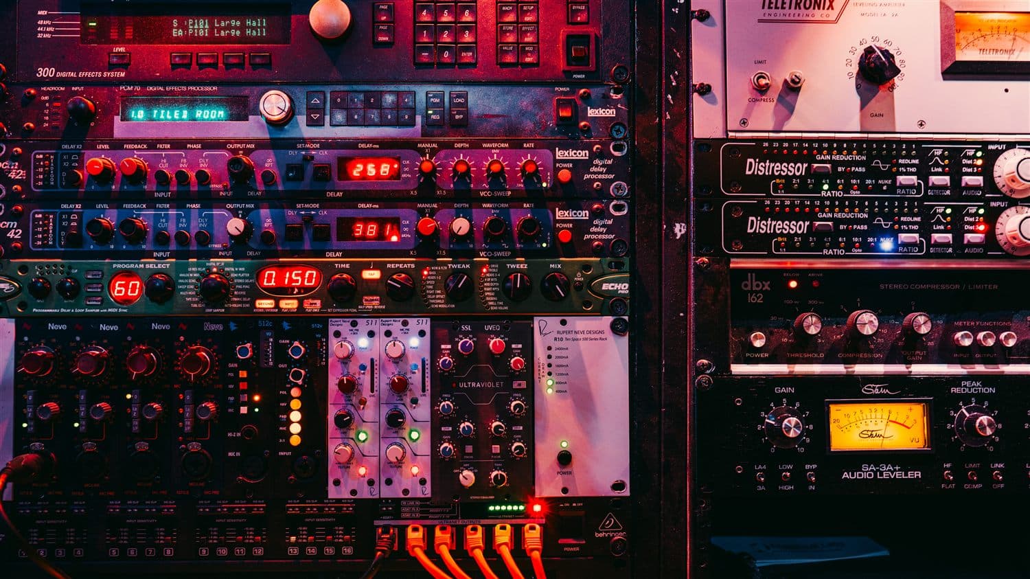The outboard rack — Distressors, Teletronix, Lexicon, dbx — wired with red patch cables