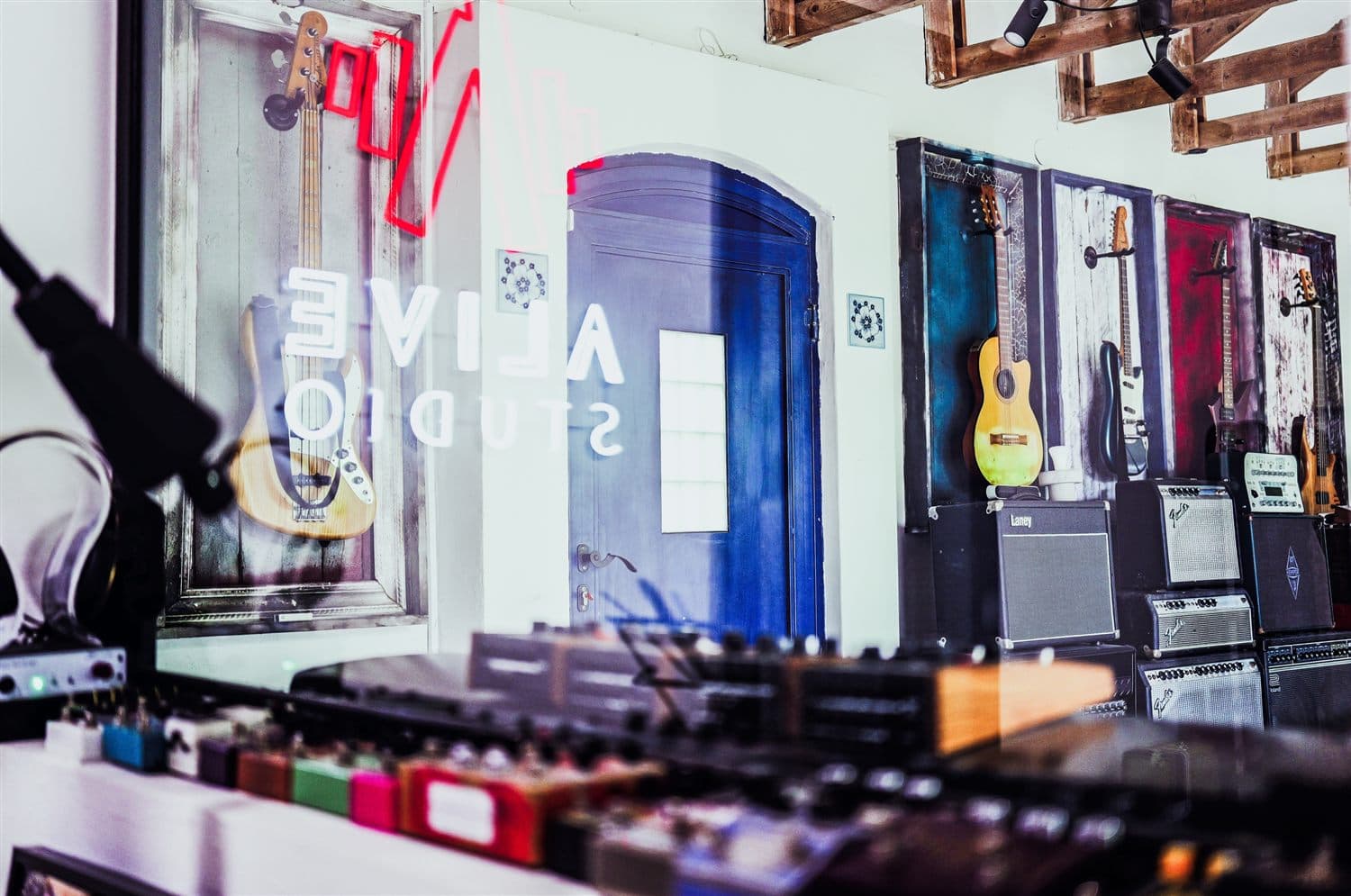 The live room with amps, instruments and the neon Alive sign